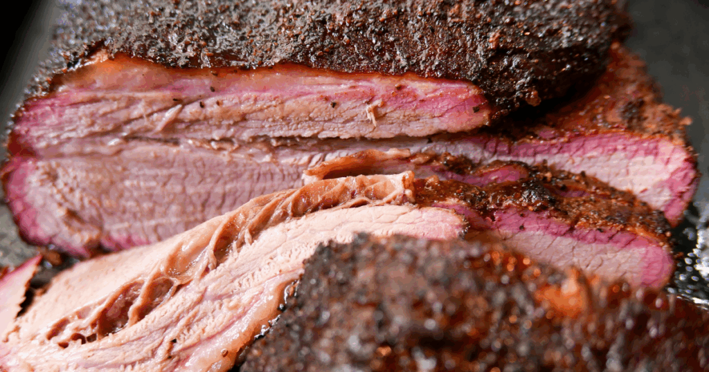 Close-up of Kansas City-style smoked brisket with juicy texture and seasoned bark