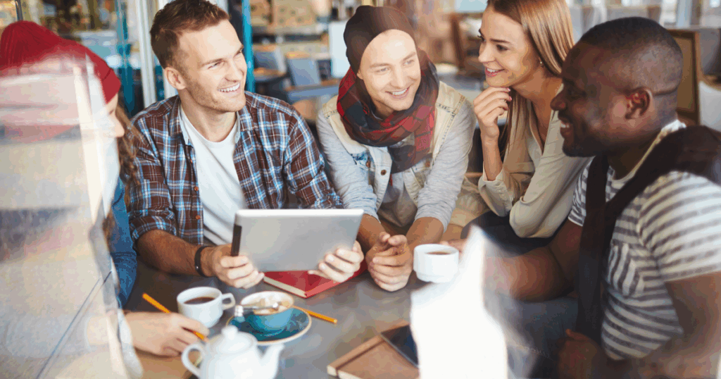 Diverse group of young adults enjoying coffee and conversation, representing community and connection