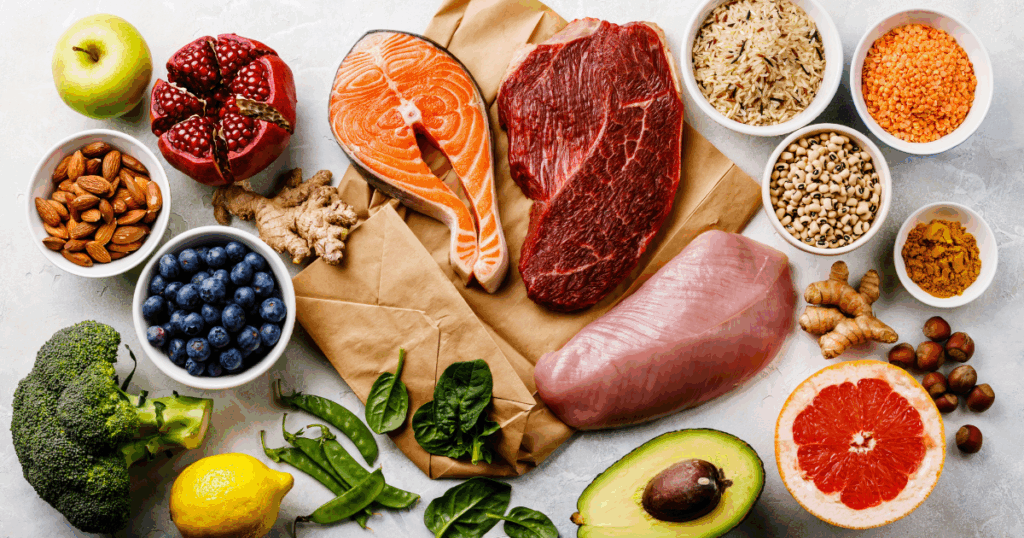 Assorted lean meats including salmon, chicken, and beef paired with legumes, nuts, eggs, and vegetables — ideal for a high-protein diet and health benefits.
