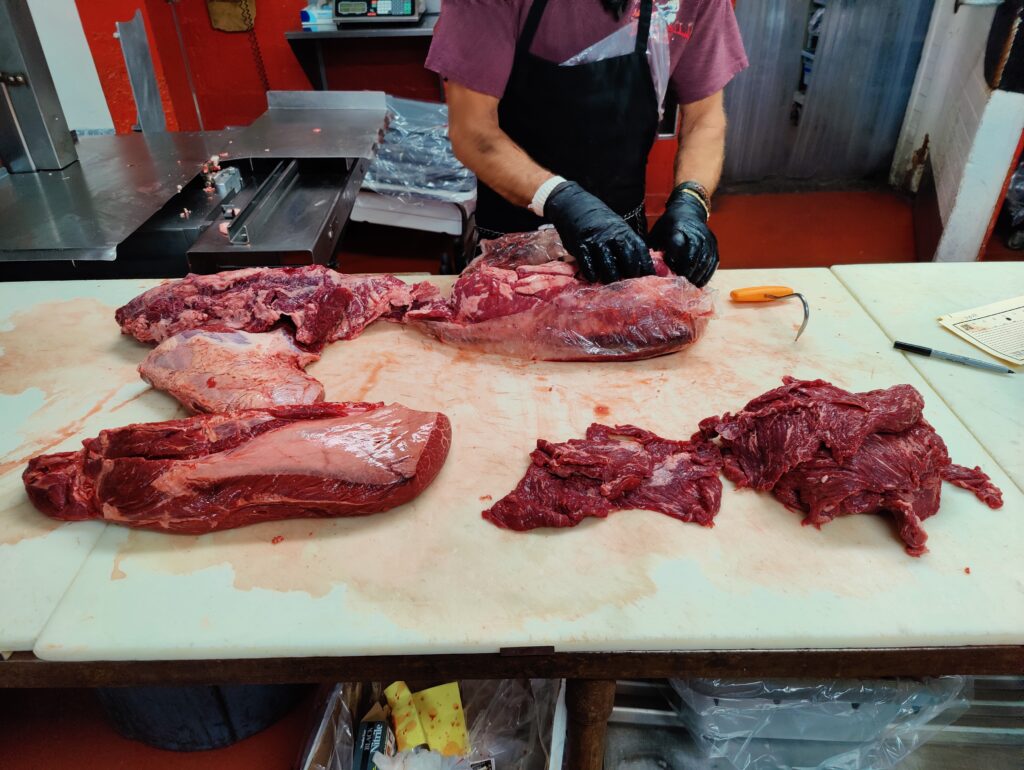 Owner Chuck Frommer and Butcher preparing the right cut of meat at John Mull’s Meats in Las Vegas