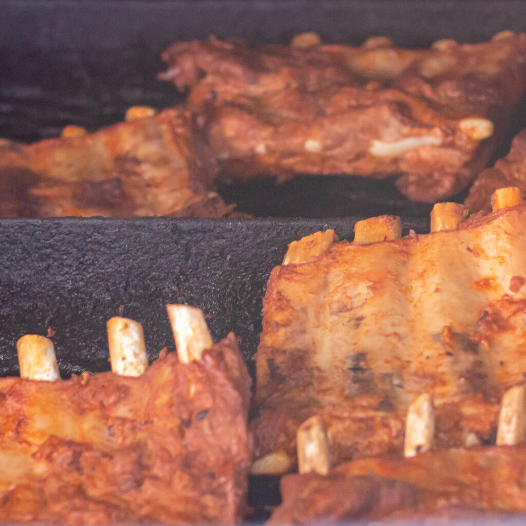Fall-off-the-bone ribs smoking on the grill at John Mull’s Road Kill Grill in Las Vegas