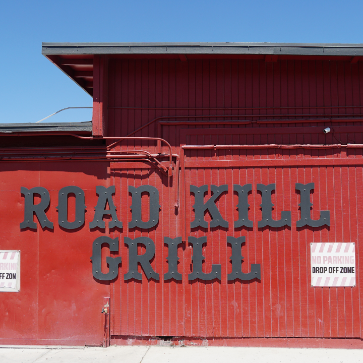 Exterior of Road Kill Grill in Las Vegas with bold signage on a red wall