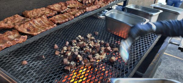 BBQ pitmaster at John Mull’s Road Kill Grill showing differences in meat cooking techniques