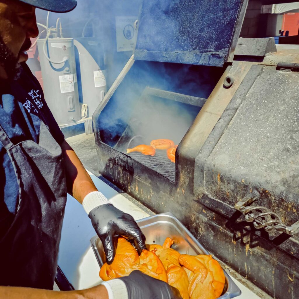 Slow-smoked pork ribs being prepared at John Mull’s Road Kill Grill in Las Vegas BBQ pit