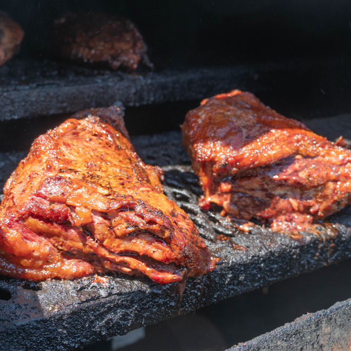 Juicy smoked brisket cooking slow on a black smoker at John Mull’s Road Kill Grill in Las Vegas