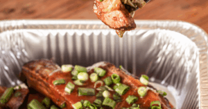 Smoked pork ribs with scallions served in a foil tray at John Mull’s BBQ in Las Vegas