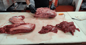 Butcher preparing fresh beef cuts by hand at John Mull’s Meats in Las Vegas. Way better than any grocery store.