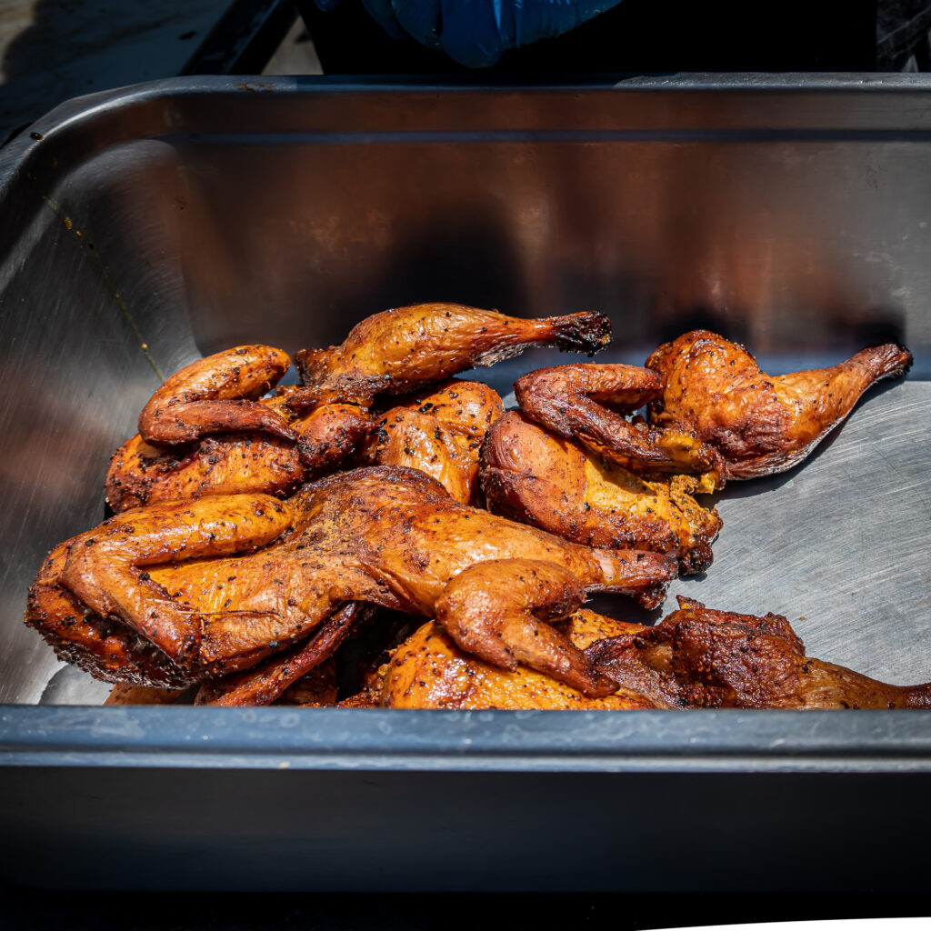 Smoker filled with sausages, smoked chicken, and brisket at John Mull’s Meats in Las Vegas, prepared fresh for Thanksgiving BBQ orders.