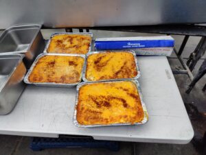 Fresh trays of baked mac and cheese at John Mull’s Meat Market in Las Vegas, prepared for Thanksgiving BBQ catering and family holiday meals.