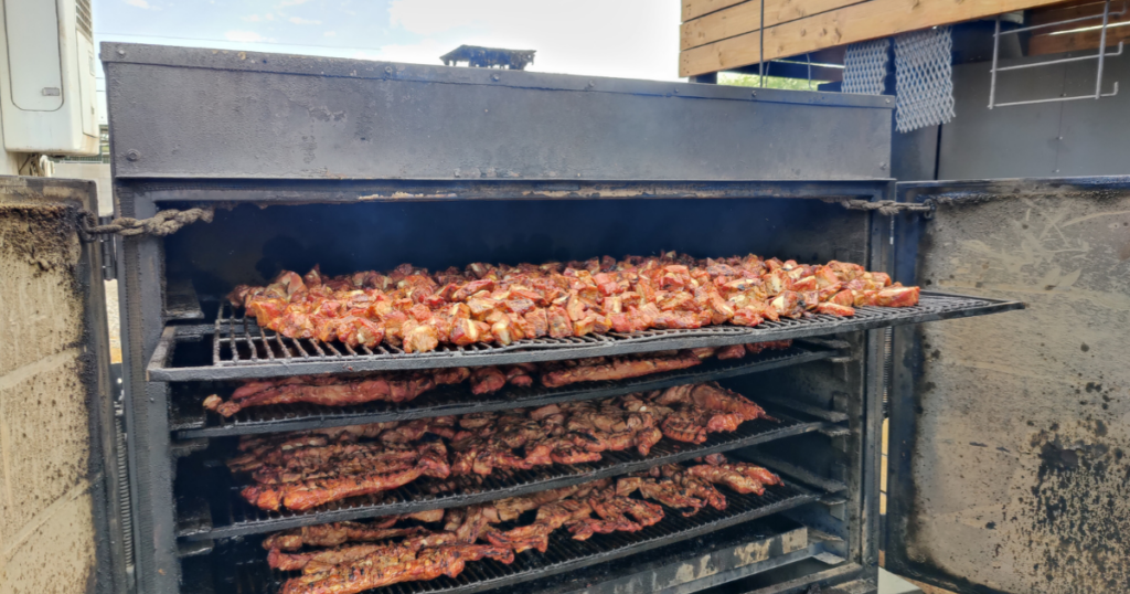 BBQ smoker filled with slow-smoked meats in Las Vegas BBQ restaurant