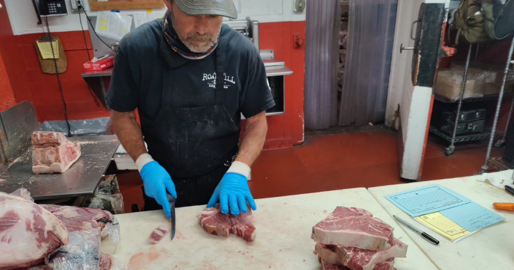 The best butcher cutting fresh meat at John Mull’s Meats, a trusted Las Vegas meat market and butcher shop known for quality cuts.