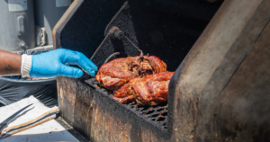 Slow-smoked brisket cooking on the smoker at John Mull’s Road Kill Grill, a famous Las Vegas BBQ restaurant known for smoked meats.