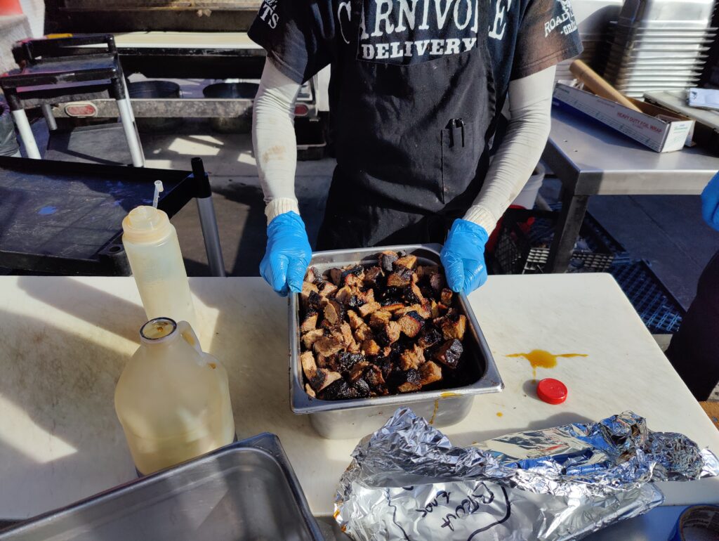 John Mull's Meats staff packaging fresh slow-smoked burnt ends for BBQ catering Las Vegas orders at Road Kill Grill.