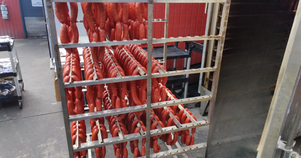 House-made smoked sausages hanging inside the smokehouse at the best BBQ place at John Mull's Meats and Road Kill Grill in Las Vegas.