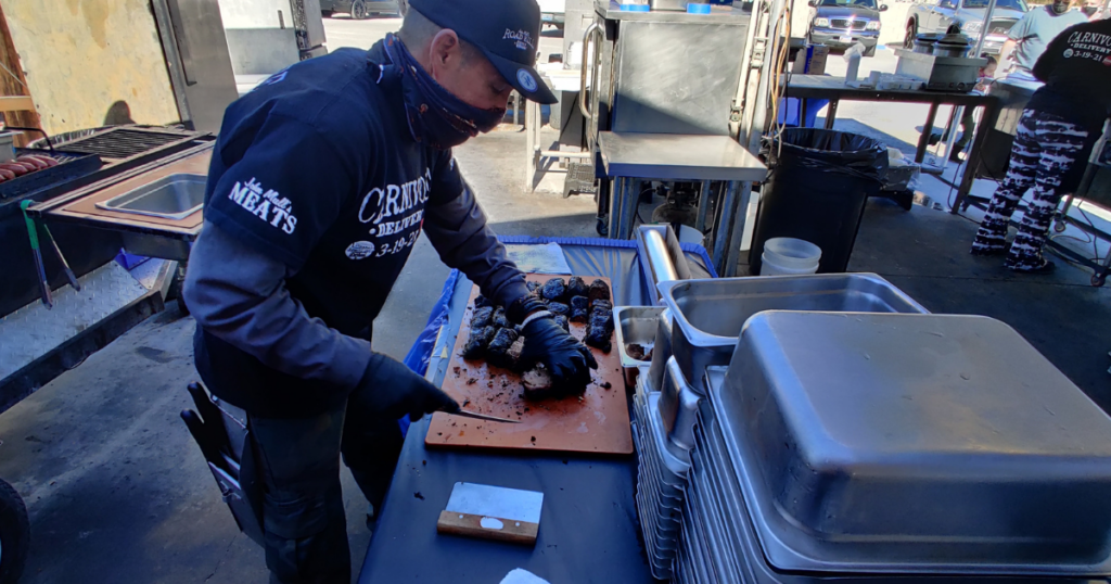 Pitmaster slicing freshly smoked burnt ends at Road Kill Grill, one of the best BBQ restaurants in Las Vegas.