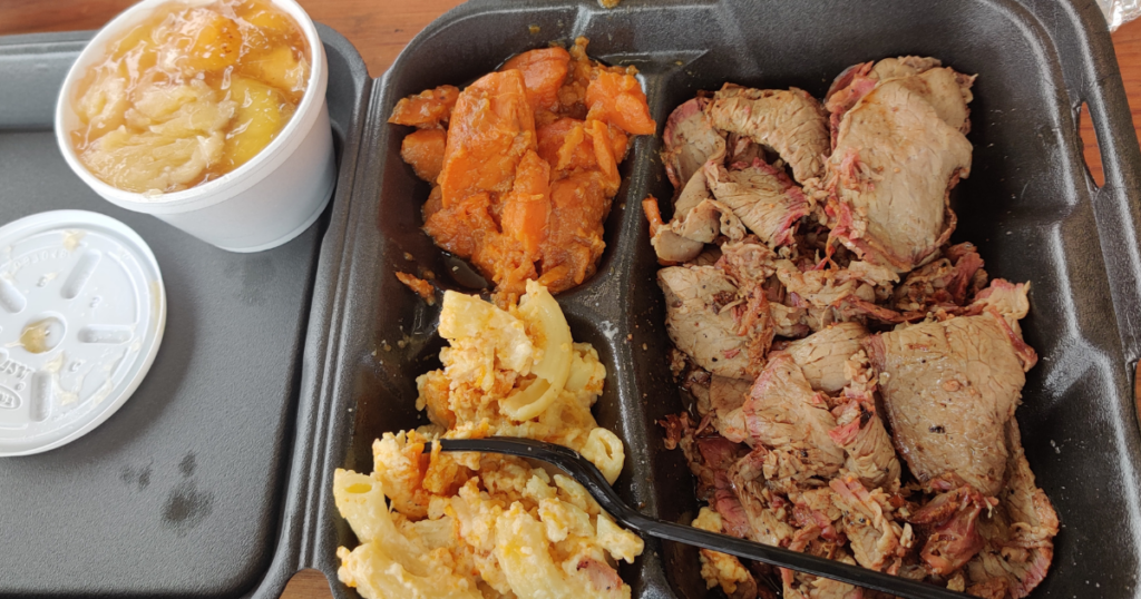 Road Kill Grill in Las Vegas smoked brisket platter with creamy mac and cheese, candied yams, and authentic BBQ sides.